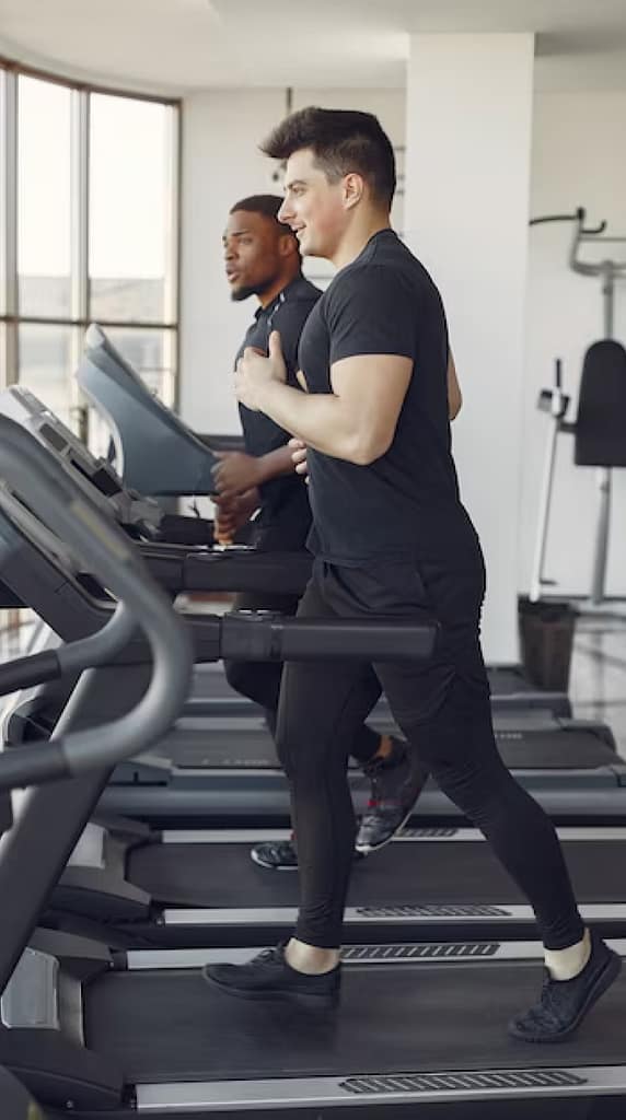 Two men on treadmills serviced by ServiceRX