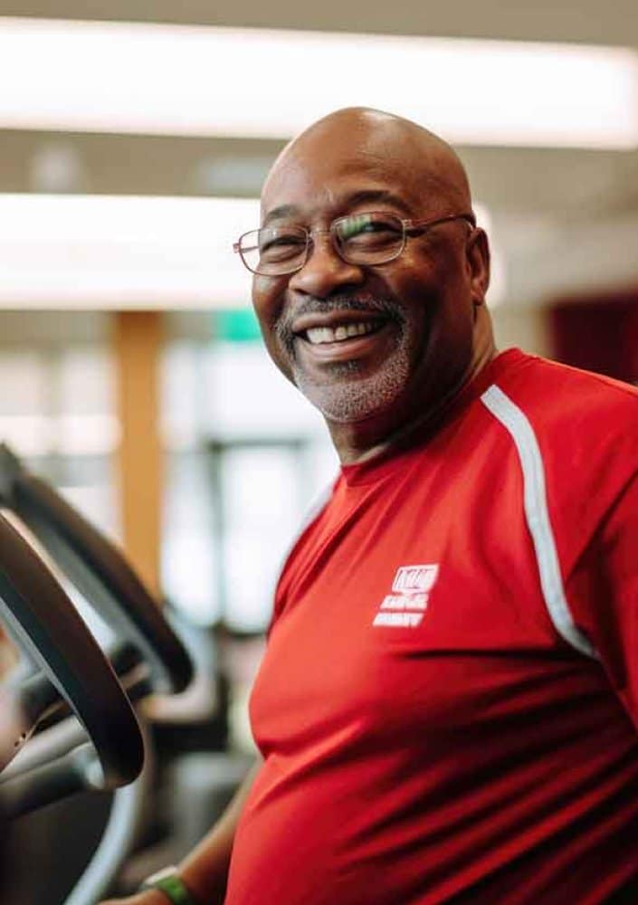 Man smiling while working out after a ServiceRX elliptical repair