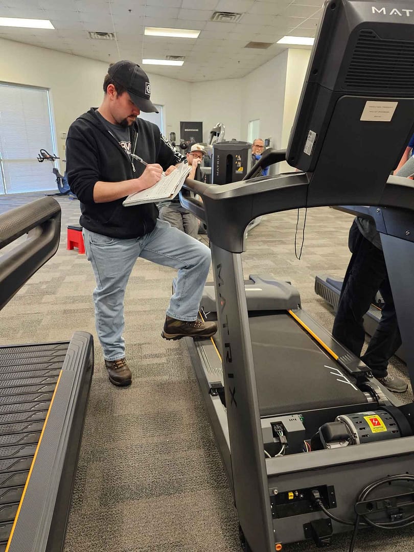 ServiceRX service technician making a fitness equipment repair.