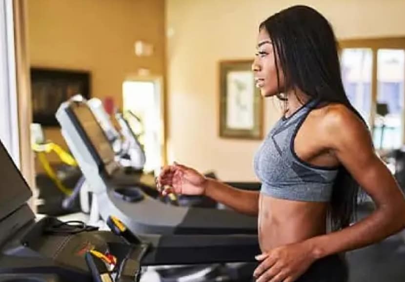 Woman running on a treadmill after a fitness equipment repair.